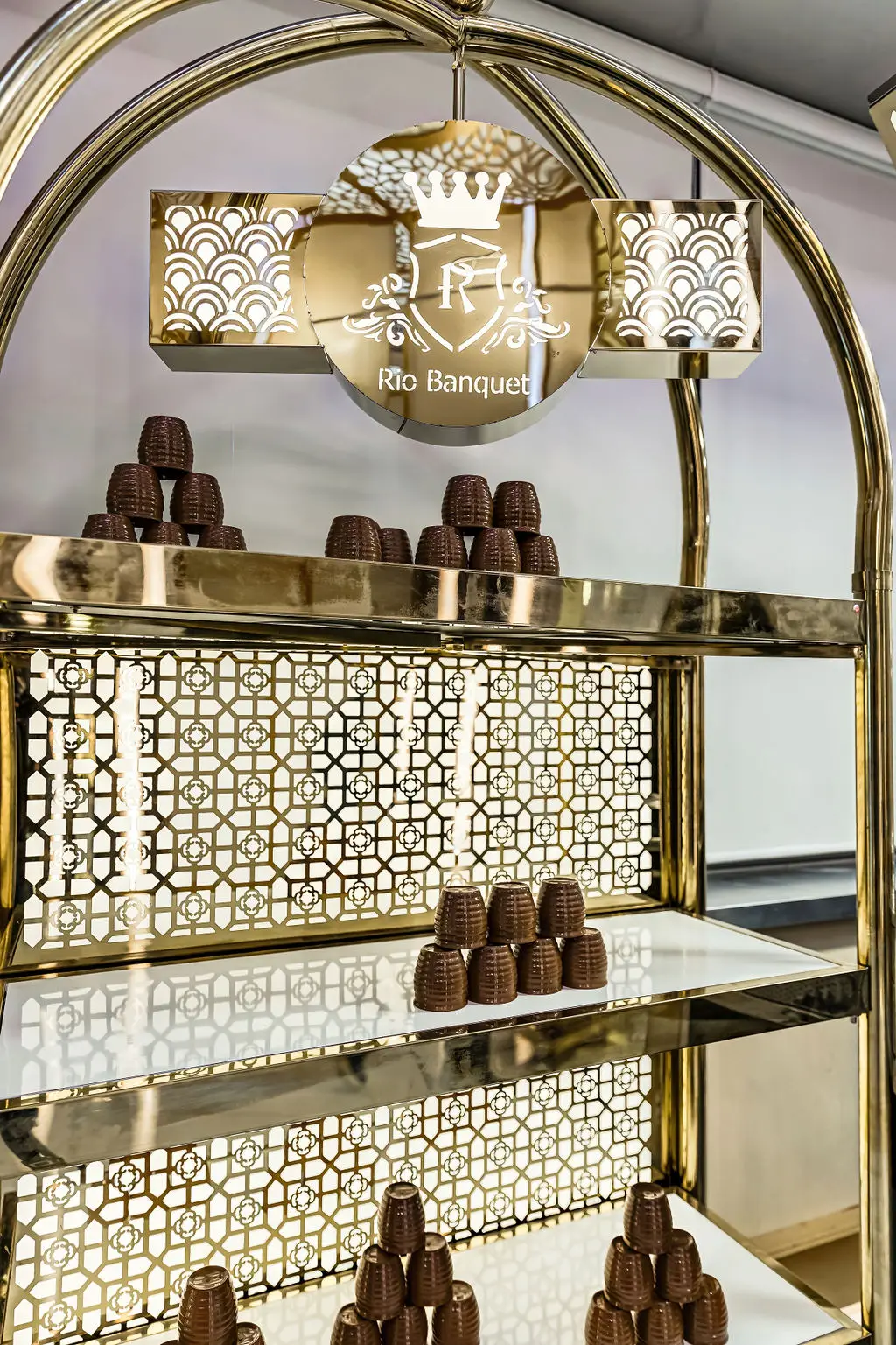 Clay kulhad cups displayed on a backlit gold lattice shelf