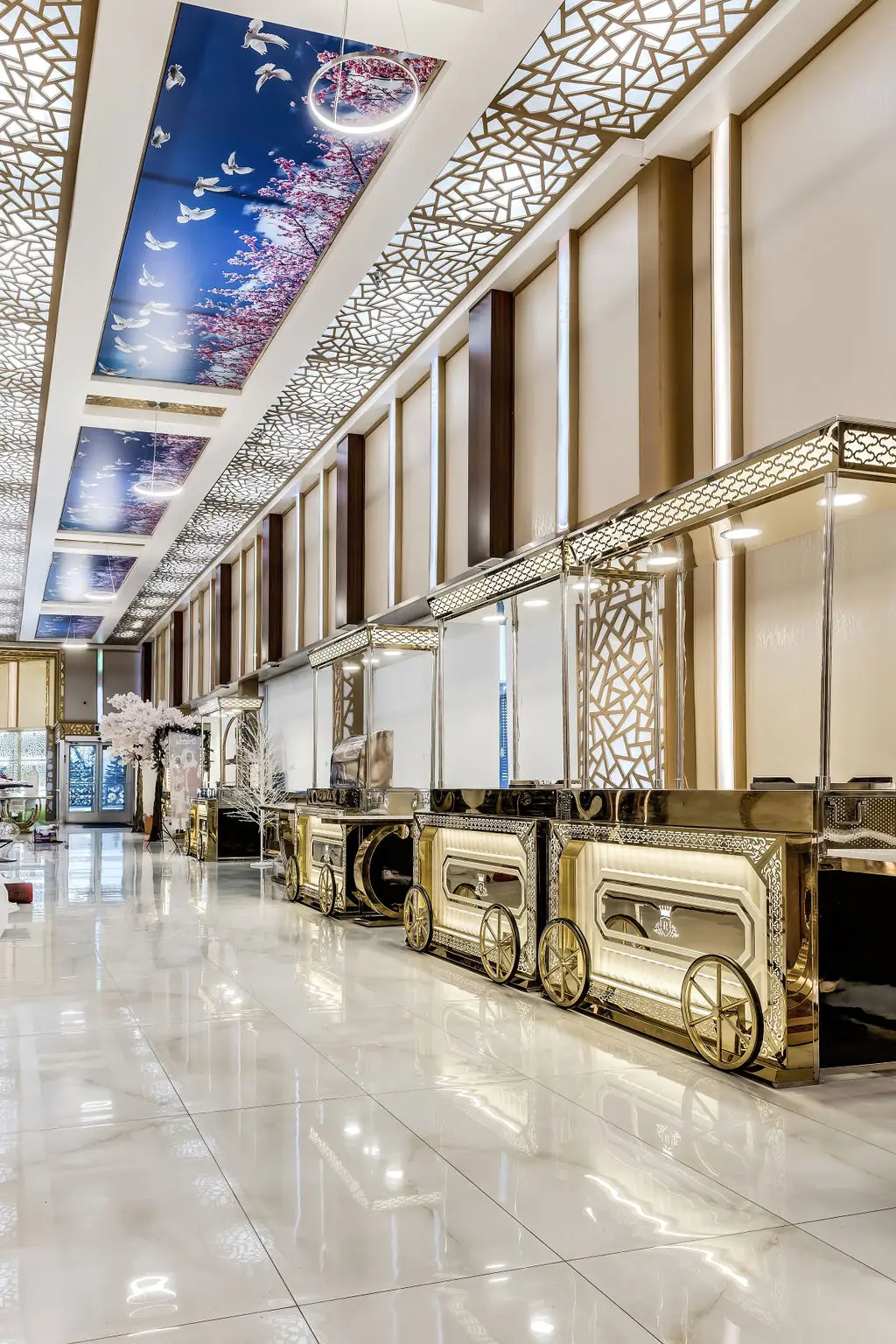 Long marble-floored buffet gallery lined with gold carriage-style serving stations