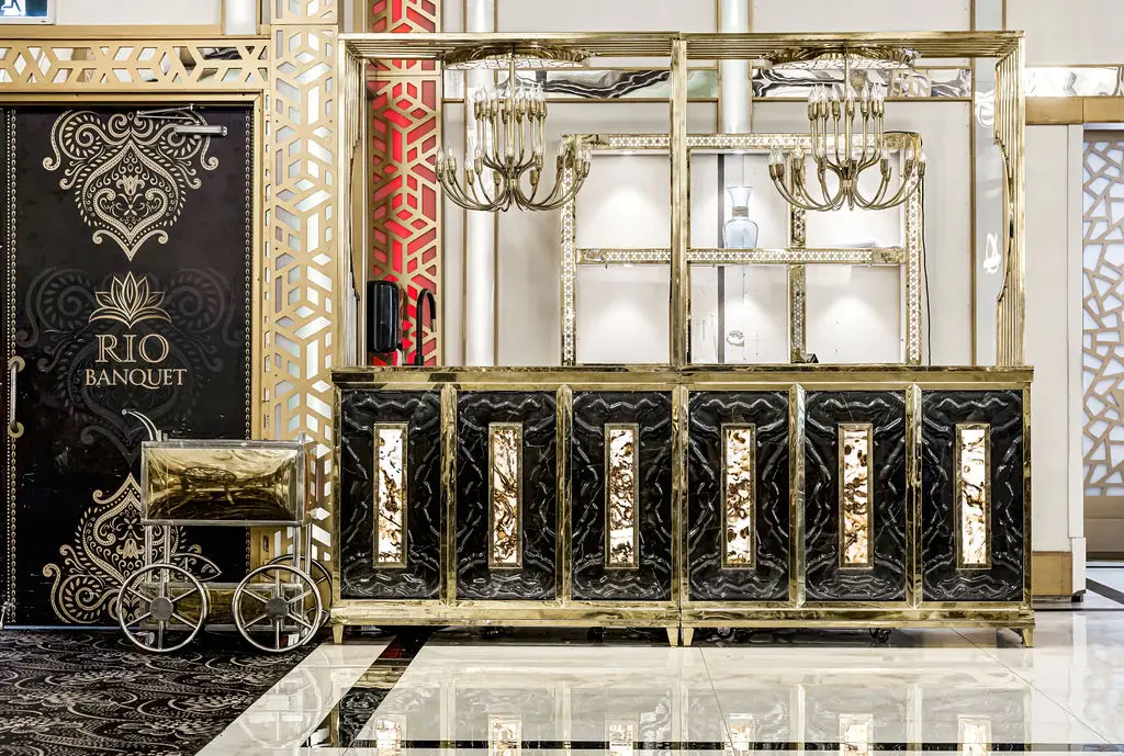 Black and gold carved service counter with a gold carriage display